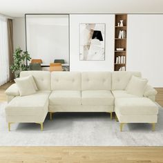 a living room with a sectional couch and bookshelf in the corner, along with a rug on the floor