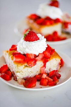 there is a piece of cake with strawberries on it and whipped cream on top