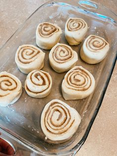 there are seven cinnamon rolls in the baking dish