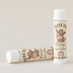 a tube of baby shower lotion sitting next to a tube of lip balm