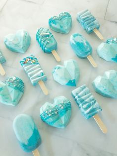 blue heart shaped lollipops on a marble table