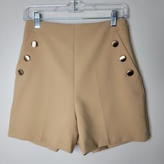 Tan High Waisted Sailor Girl Style Dressy Shorts With Gold Hardware. Zips Up On Left Side. Waist 13" Length 16" Inseam 4" Front Rise 13.5" Beige Fitted Short Skort, Fitted Beige Short Skort, Spring Shorts With Button Closure And Short Inseam, Fitted High-waisted Shorts With Button Closure, Fitted Beige Shorts With Short Inseam, Fitted Beige Mini Shorts, Fitted Mini Length Beige Shorts, Fitted Buttoned Shorts, Summer Mini Bottoms With Buttons