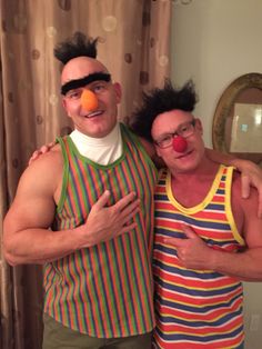 two men with clown nose and glasses posing for the camera