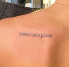 a person with a tattoo on their back saying protect your peace