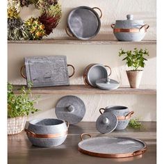 pots and plates are arranged on the shelves