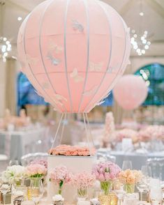 a table topped with a cake covered in frosting next to a hot air balloon