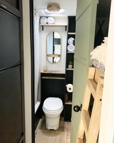 a small bathroom with a toilet and shelves