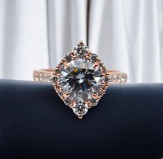 a diamond ring on top of a black cloth