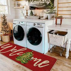 a washer and dryer sitting in a room next to a christmas tree on the floor