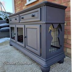 an old dresser has been painted gray with gold accents and is next to a brick wall