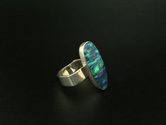 Hi everyone, just wanted to let you know we are open and shipping daily. One of a kind opal and sterling silver ring in unique band design. This fire opal has been cultured in Japan over a three year period and contains the same chemical composition as natural opal. As with the rest of this line of jewelry the quality and workmanship is unrivaled. This line has sold in my San Francisco store for more than twice the etsy price we are offering. Modern Oval Opal Ring, Modern Sterling Silver Opal Ring, Modern Sterling Silver Oval Opal Ring, Oval Opal Ring Stamped 925, Fire Opal Earrings, Blue Fire Opal, Unique Bands, Larimar Pendant, Fire Opal Ring