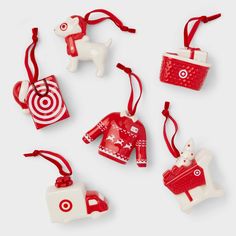 red and white ornaments are arranged in the shape of dogs, baskets, and bags