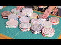 a person is cutting up some cake on a table