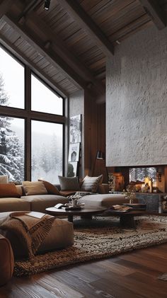 a living room filled with furniture and a fire place in front of a large window