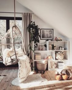 a living room with a hammock chair and bookshelf in the corner