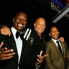 three men in tuxedos posing for the camera