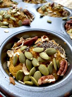 a muffin tin filled with lots of different types of nuts and other food items