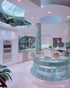 a large kitchen with marble counter tops and spiral stairs