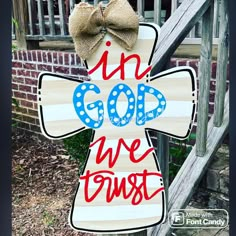 a wooden cross with the words i'm god we trust painted on it