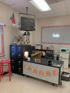 a classroom with desks, chairs and television