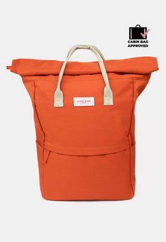 an orange tote bag with white handles and straps on the bottom, in front of a