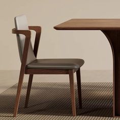 a wooden table with two chairs next to it and a brown rug on the floor