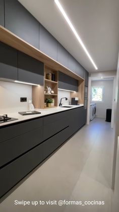 a kitchen with gray cabinets and white counter tops