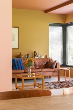 a living room filled with furniture next to a window