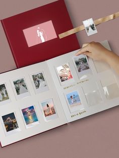 a person holding an open photo album with pictures on the cover and ribbon attached to it