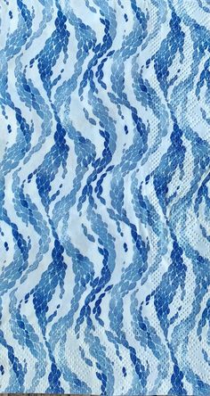 a blue and white fabric with wavy lines