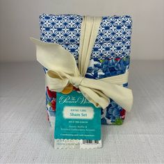 a blue and white gift bag with a ribbon tied around it