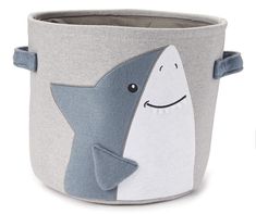 a grey and white storage basket with a smiling shark on it