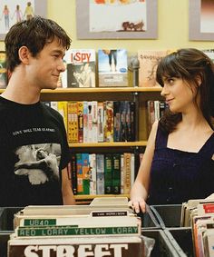 a man and woman standing in front of books