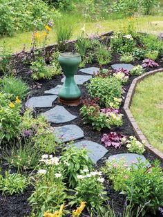 a garden filled with lots of different types of flowers and plants on top of rocks