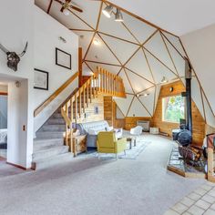 a large open living room with stairs leading up to the second floor and an upstairs loft