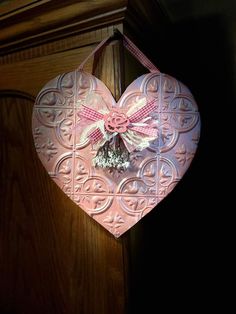 a heart shaped decoration hanging on a door