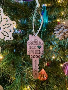 a christmas ornament hanging from the top of a tree with ornaments around it