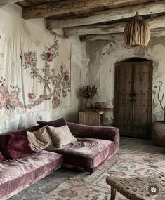 a living room filled with furniture next to a wall covered in tapes and flowers on the walls