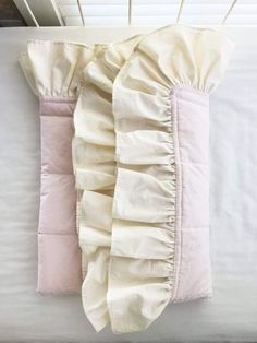 a white pillow with ruffles on top of it