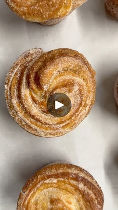 several pastries are arranged on a white surface and one has a hole in the middle