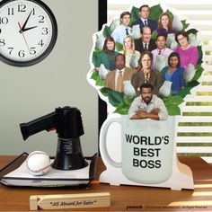 a coffee mug with the faces of actors on it next to a baseball bat and an alarm clock