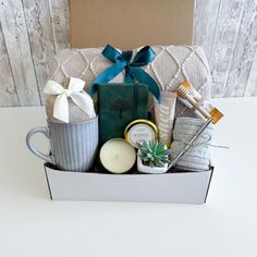 a gift box filled with candles and other items