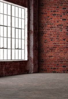 an empty room with brick walls and bars on the windows