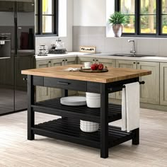 a kitchen island with plates and bowls on it in the middle of a floored room