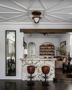 a living room filled with furniture and a bar