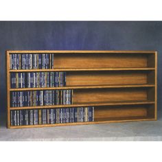 a wooden shelf with several dvd's on it and two shelves holding various movies