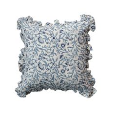 a blue and white pillow with ruffled edges