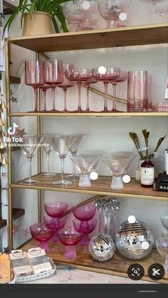 a shelf filled with lots of wine glasses