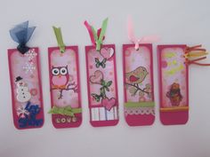 four pink bookmarks with birds and hearts on them, hanging from ribbon ties next to each other