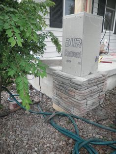 a cement box sitting on top of a pile of rocks